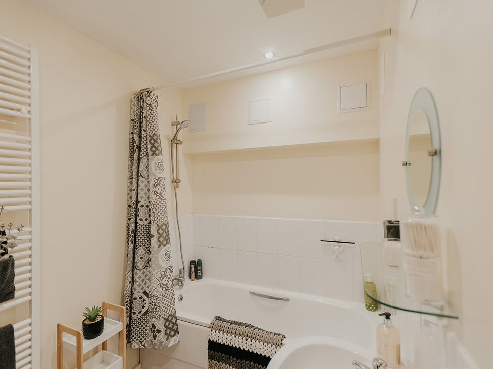 A bathroom with a bathtub and shower at 5 Mariners Wharf in Newhaven