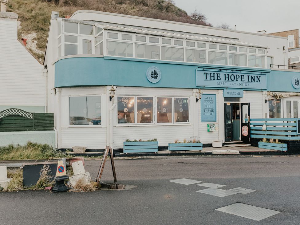 A pub exterior with windows and signage at The Hope Inn in Newhaven