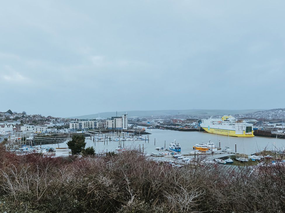 A marina with boats and buildings at 5 Mariners Wharf in Newhaven