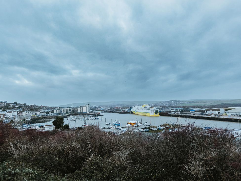 A harbor with boats and buildings at 5 Mariners Wharf Newhaven