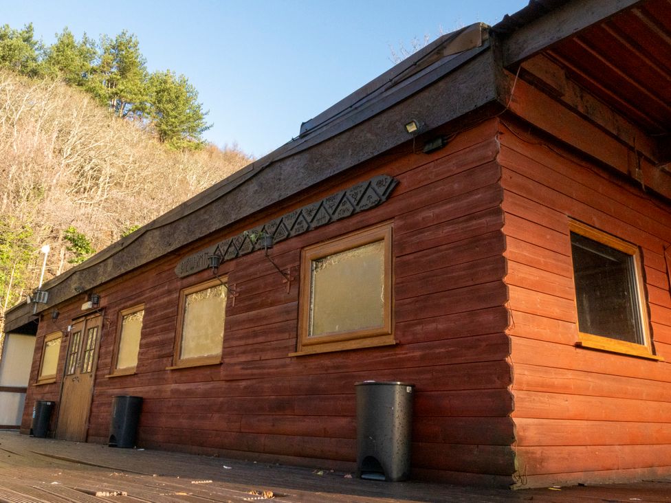 A wooden building with windows and a door at 3-bedroom Cabin (2 of 13) Port Talbot