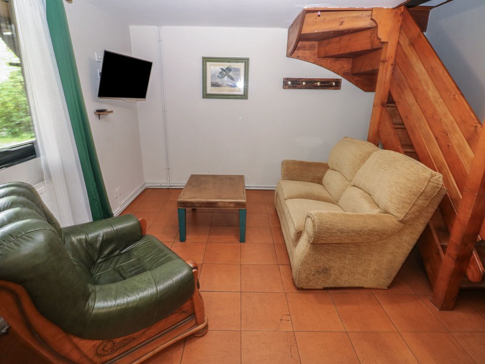 A living room with a coffee table and sofa at Cabin No. 2 - Salt and Fern Cabins Goytre near Port Talbot