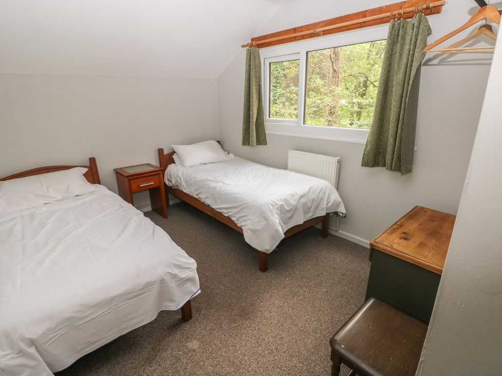 A bedroom with two beds and a window at Cabin No. 2 - Salt and Fern Cabins Goytre near Port Talbot