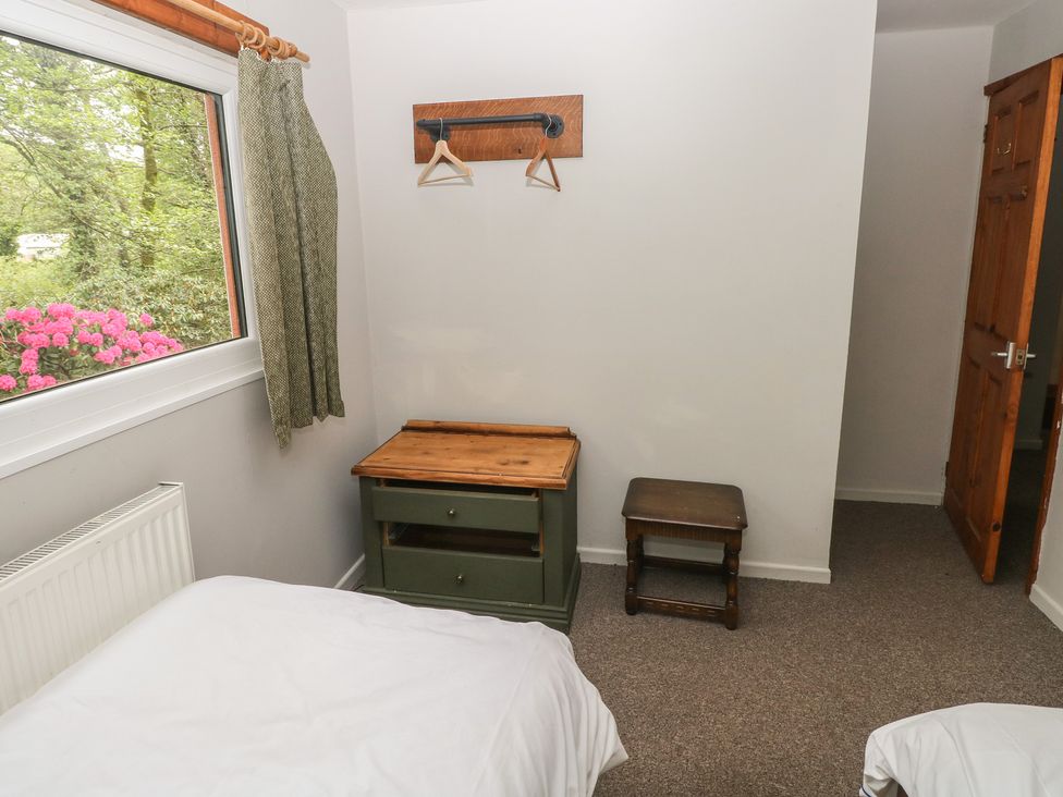 A bedroom with a bed and nightstand at Cabin No. 2 - Salt and Fern Cabins Goytre near Port Talbot