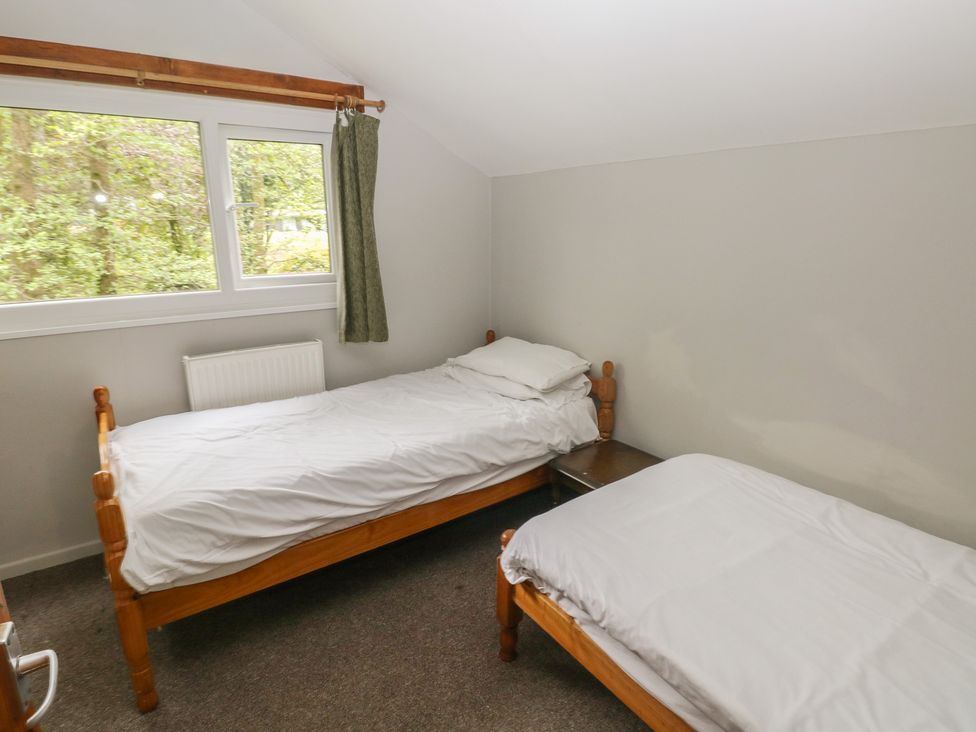 A bedroom with two beds and a window at Cabin No. 2 - Salt and Fern Cabins in Goytre near Port Talbot