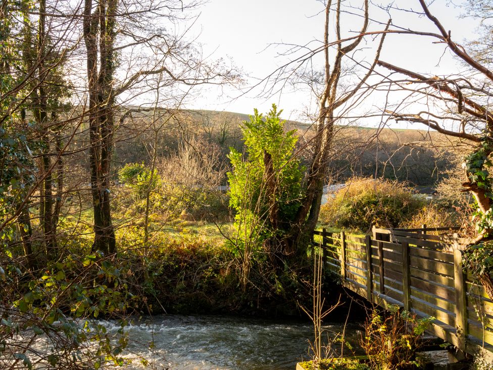 An outdoor scene with a river and footbridge at a natural location in Port Talbot