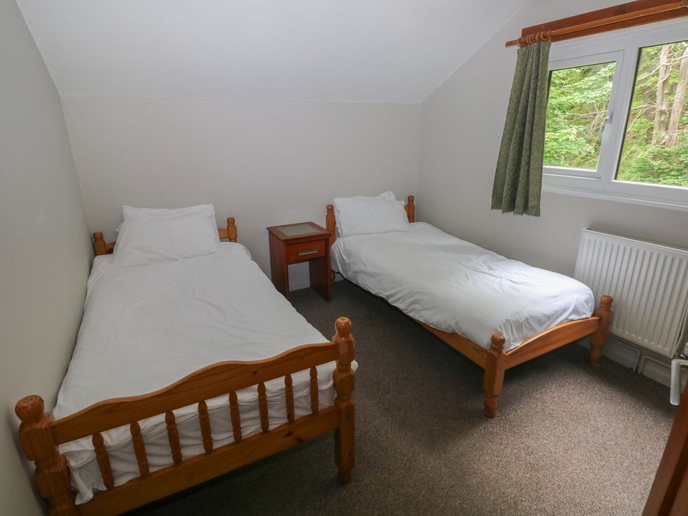 A bedroom with two beds and a nightstand at Cabin No. 5 - Salt and Fern Cabins Goytre near Port Talbot