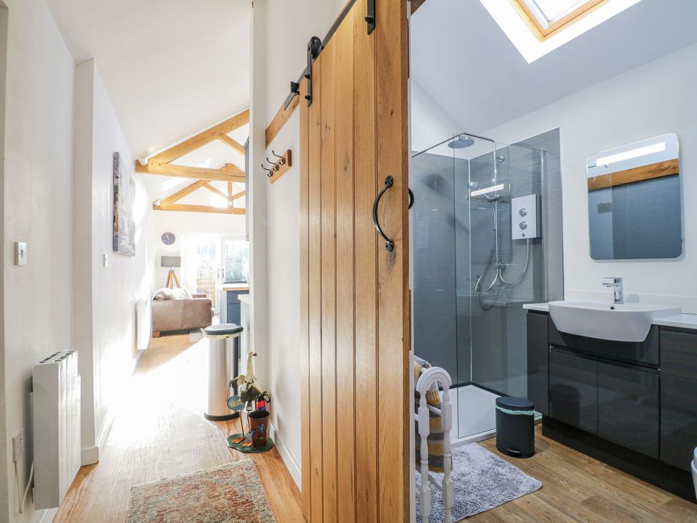 A bathroom with a shower and sink at The Garden Cottage in Hinckley