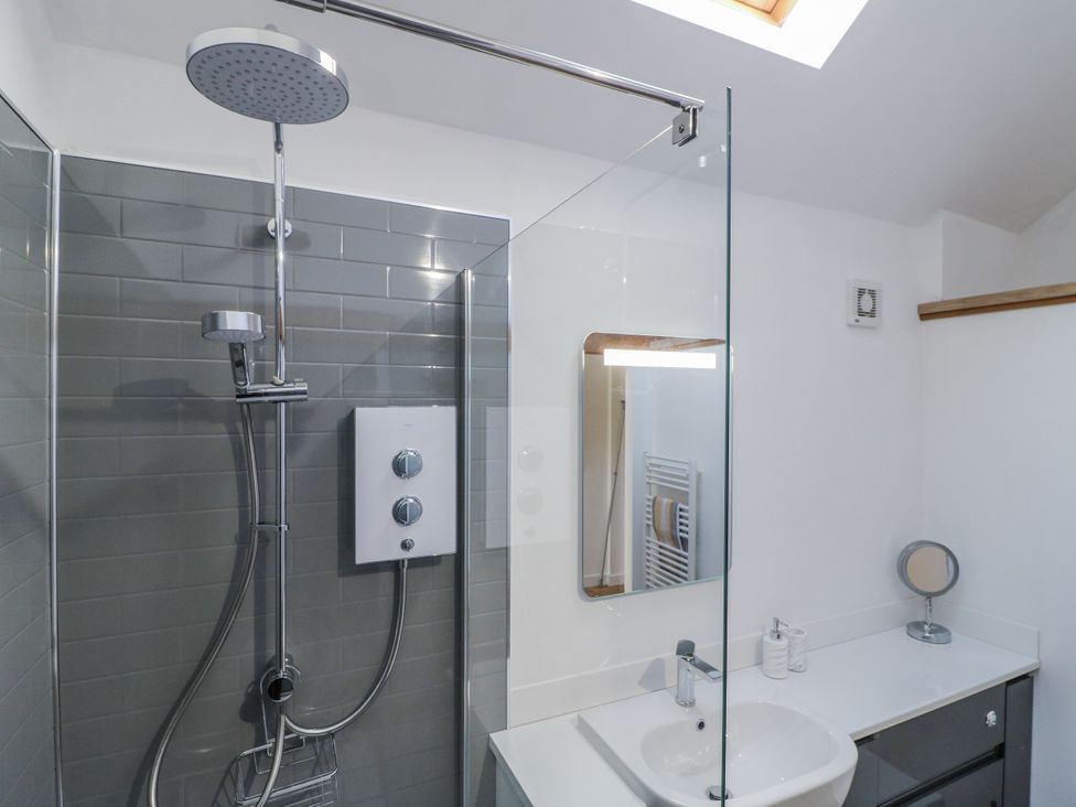 A bathroom with a shower and sink at The Garden Cottage in Hinckley