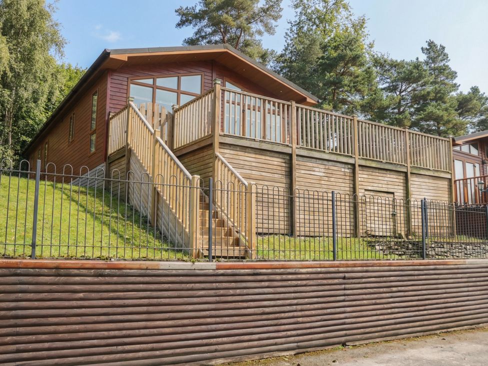 A house with a deck and stairs at High Lake View Lodge White Cross Bay near Troutbeck Bridge