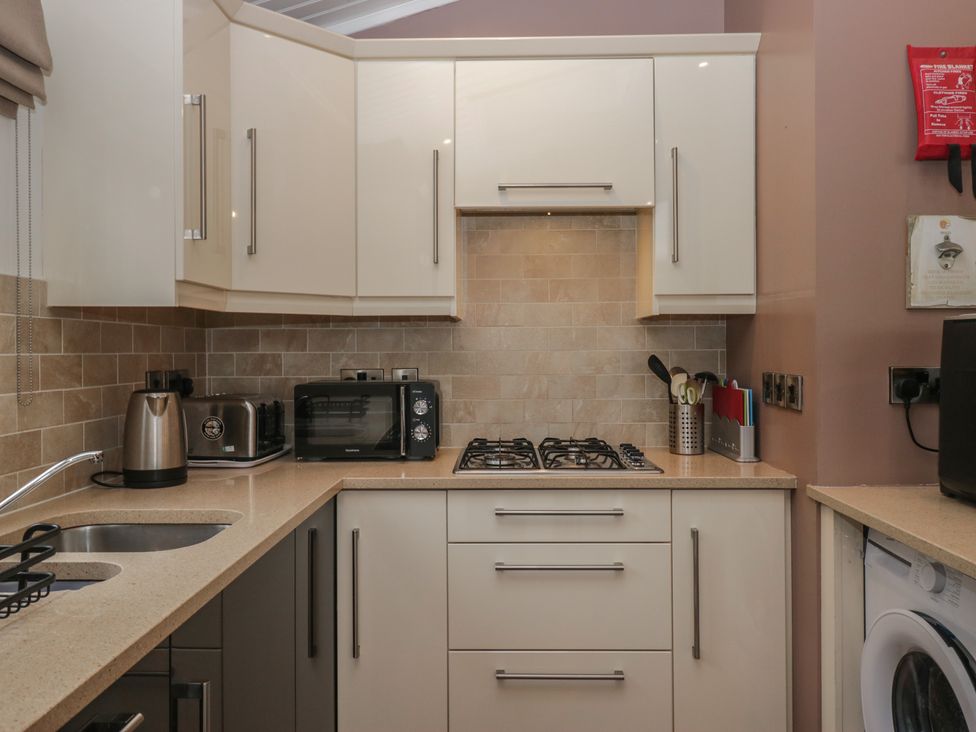 A kitchen with appliances and utensils at High Lake View Lodge White Cross Bay near Troutbeck Bridge