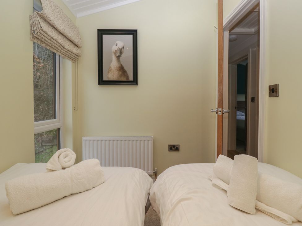 A bedroom with two beds and a picture at High Lake View Lodge in White Cross Bay near Troutbeck Bridge