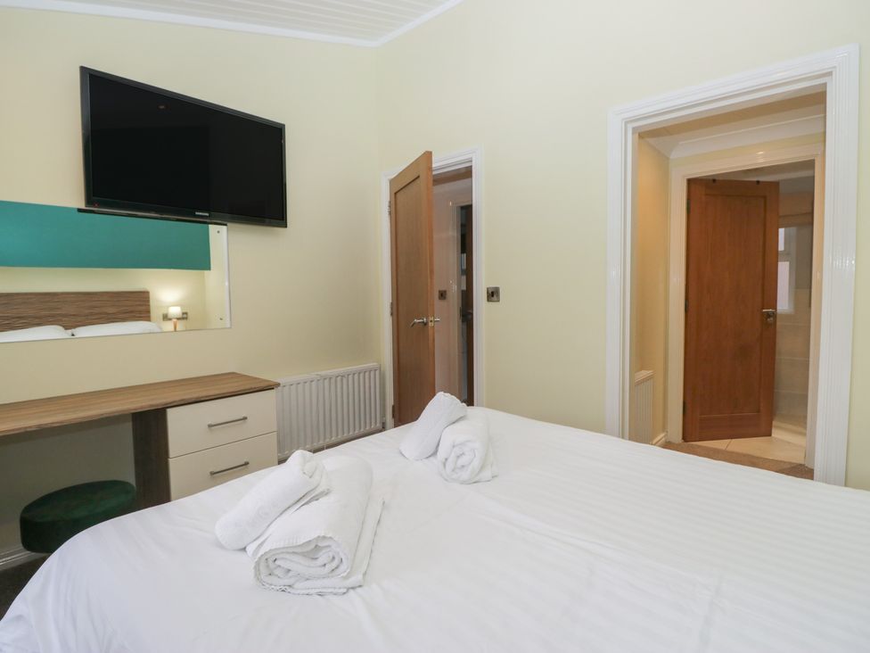 A bedroom with a bed and a television at High Lake View Lodge, White Cross Bay near Troutbeck Bridge