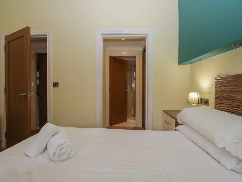 A bedroom with a bed and doors at High Lake View Lodge near White Cross Bay