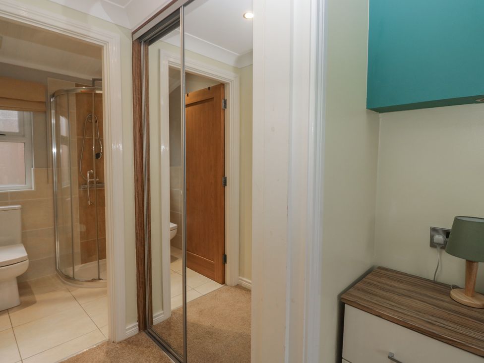 A bathroom with a shower, toilet, and sink at High Lake View Lodge White Cross Bay near Troutbeck Bridge