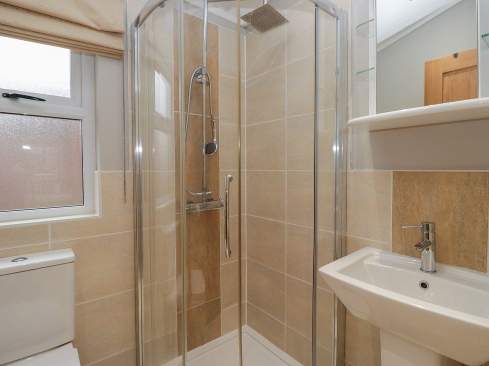 A bathroom with a shower and sink at High Lake View Lodge White Cross Bay near Troutbeck Bridge