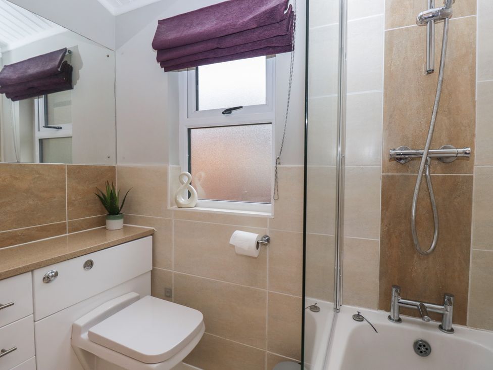 A bathroom with a sink, toilet, and bathtub at High Lake View Lodge near White Cross Bay