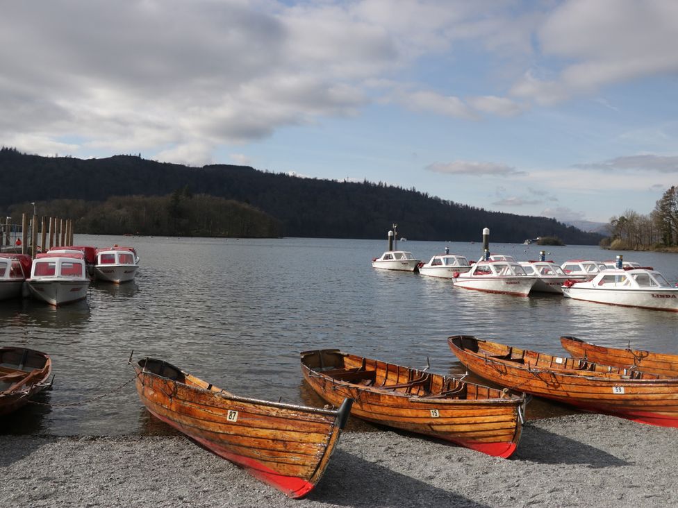A lakeside scene with boats and a pier at High Lake View Lodge White Cross Bay near Troutbeck Bridge