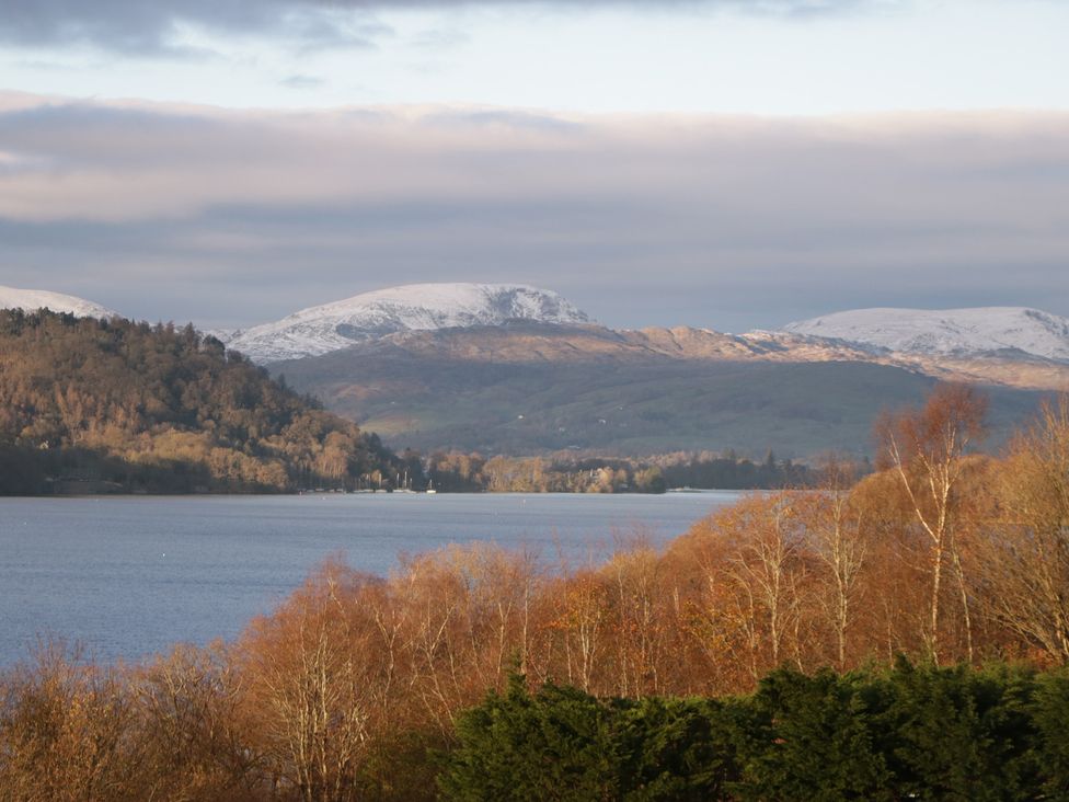 A view of a lake with mountains and trees at High Lake View Lodge White Cross Bay near Troutbeck Bridge
