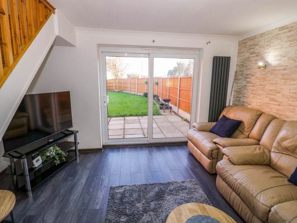 A living room with a sofa and television at 7 Waverton Mews Royal Leamington Spa
