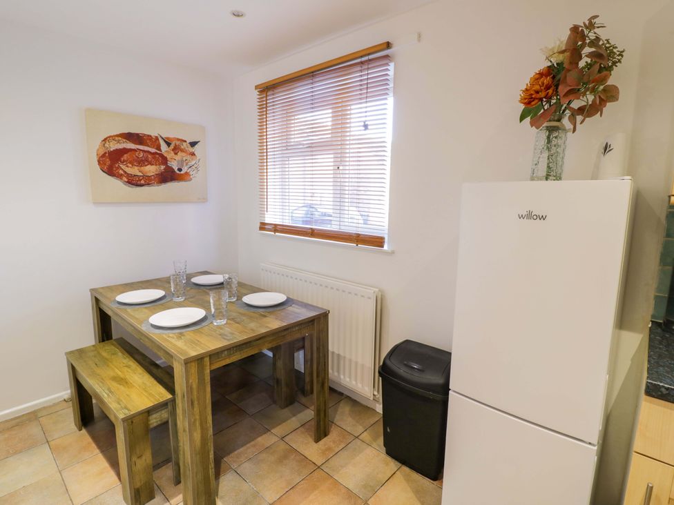 A dining room with a table and chairs at 7 Waverton Mews Royal Leamington Spa