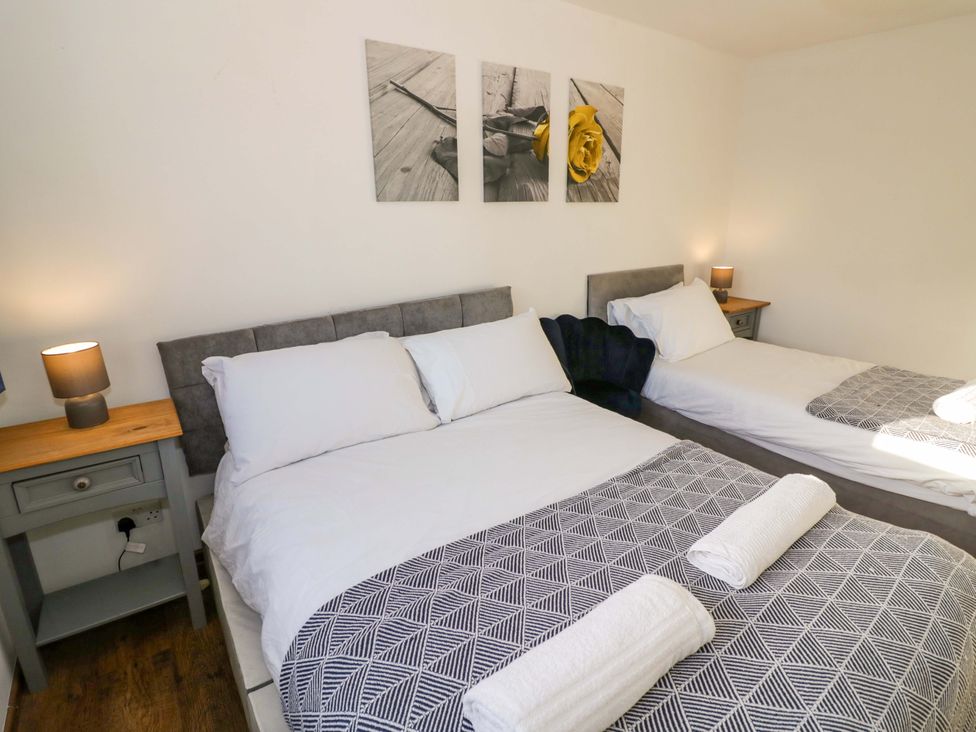 A bedroom with two beds and bedside tables at 7 Waverton Mews in Royal Leamington Spa