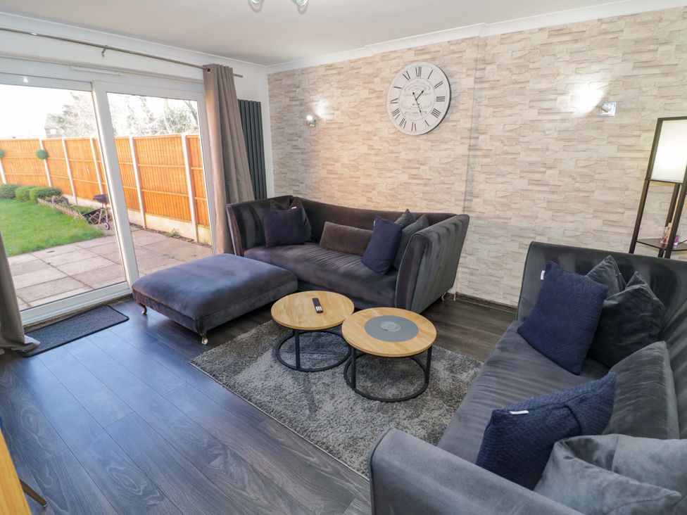 A living room with a sofa and coffee table at 7 Waverton Mews in Royal Leamington Spa