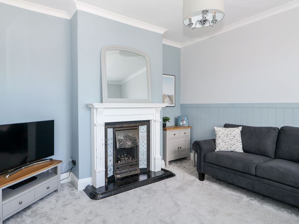 A living room with a television and fireplace at The Seaside Retreat in Mablethorpe
