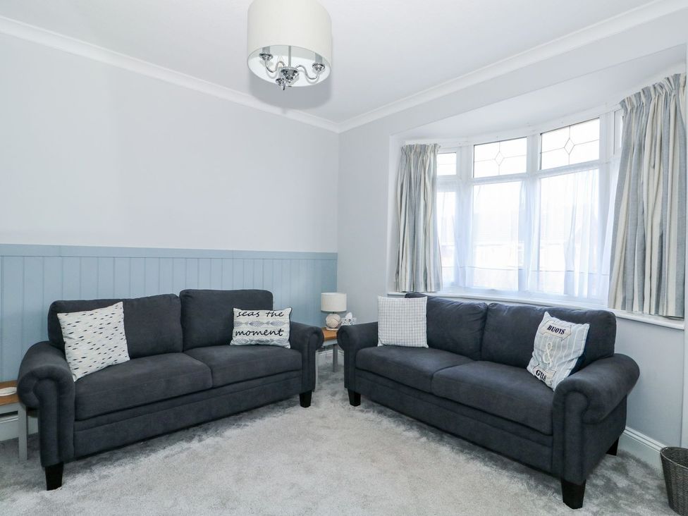 A living room with two sofas and a window at The Seaside Retreat in Mablethorpe