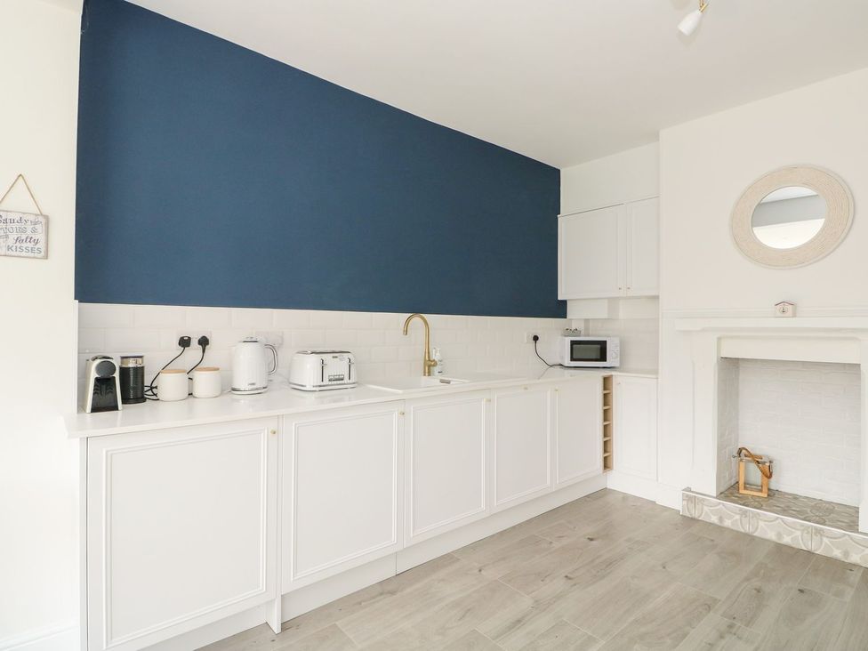 A kitchen with appliances and a sink at The Seaside Retreat in Mablethorpe