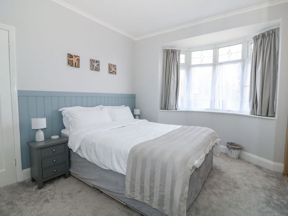 A bedroom with a bed and bedside table at The Seaside Retreat in Mablethorpe