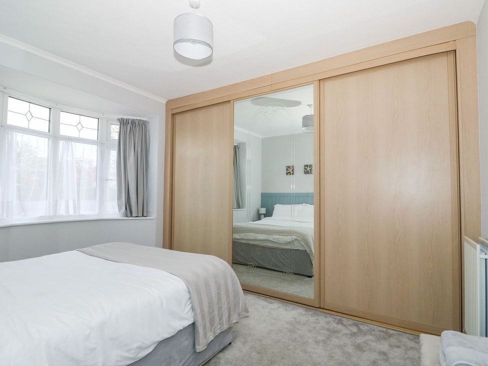 A bedroom with a bed and wardrobe at The Seaside Retreat in Mablethorpe