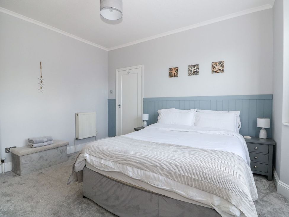 A bedroom with a bed and bedside tables at The Seaside Retreat in Mablethorpe