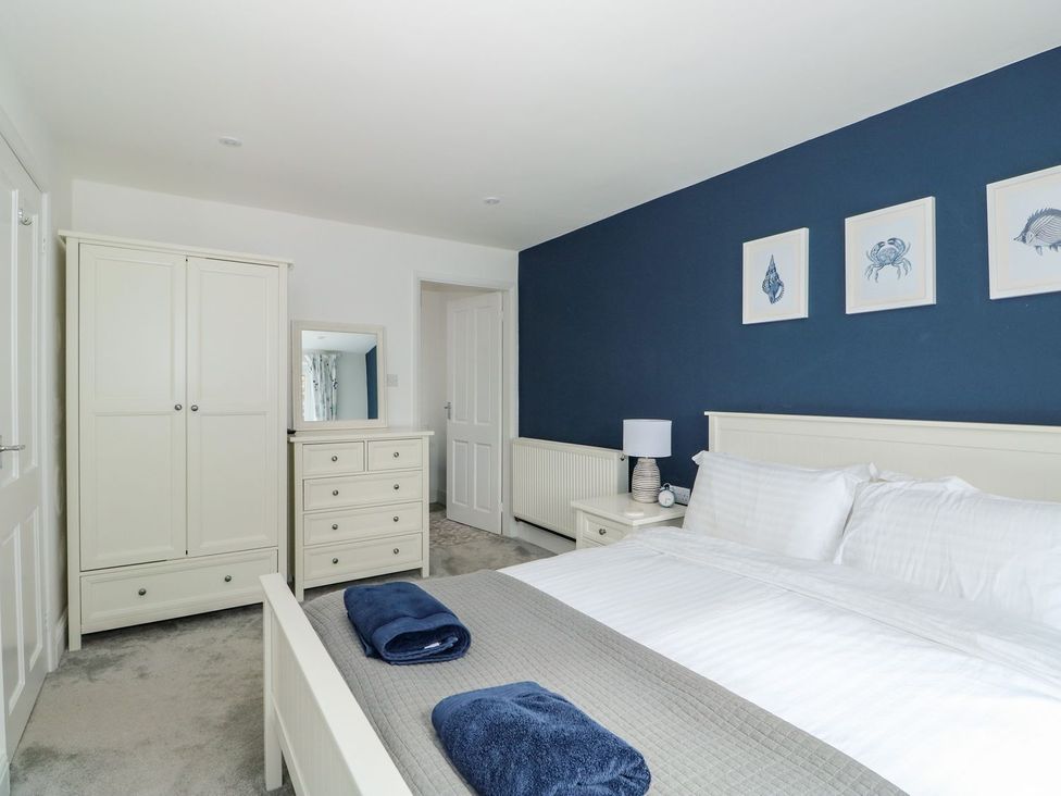 A bedroom with a bed and furniture at The Seaside Retreat in Mablethorpe