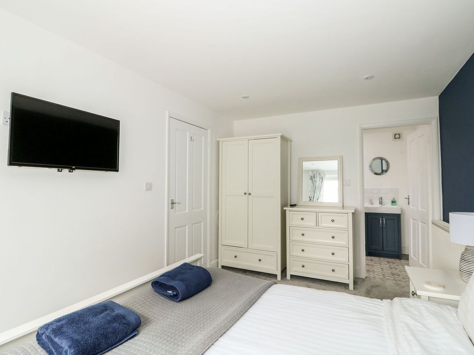 A bedroom with a bed and storage furniture at The Seaside Retreat in Mablethorpe