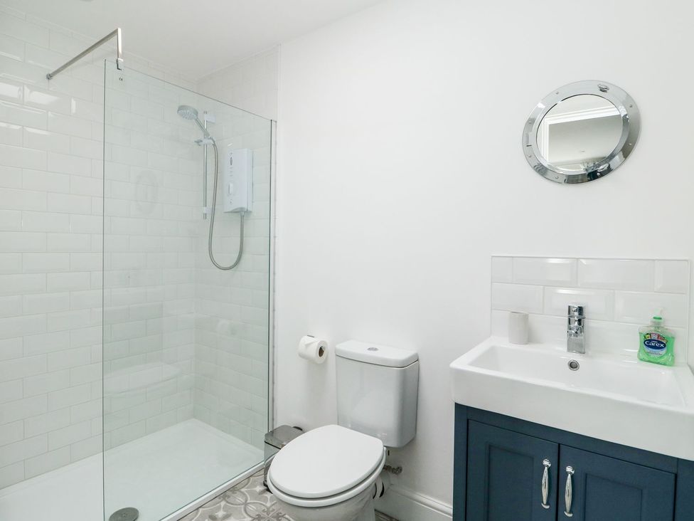 A bathroom with a shower, toilet, and sink at The Seaside Retreat in Mablethorpe