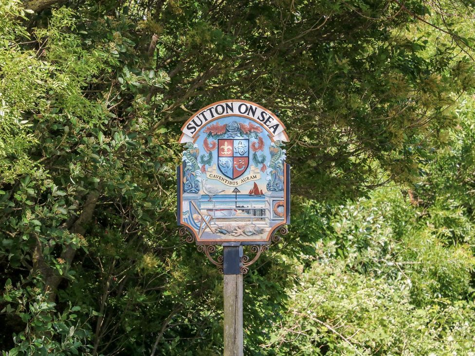 A sign for Sutton on Sea featuring a coat of arms