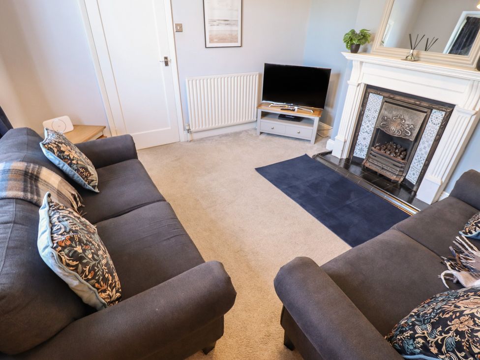 A living room with a sofa and television at The Seaside Retreat in Sutton-On-Sea