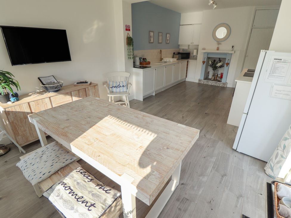 A kitchen with a table and chairs at The Seaside Retreat in Sutton-On-Sea