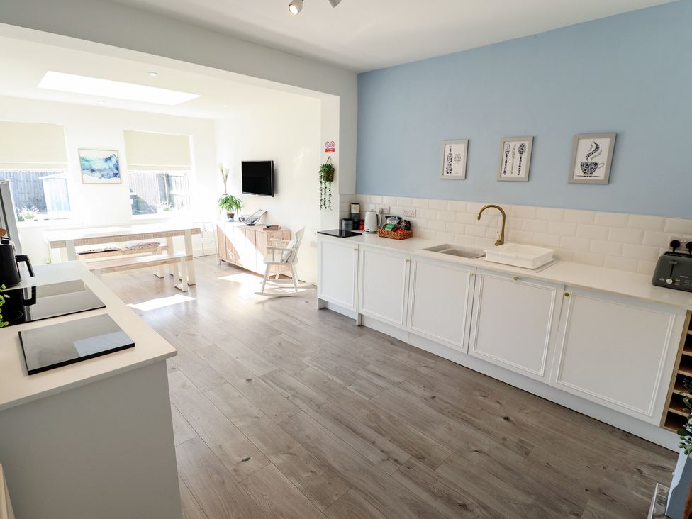 A kitchen with a sink and cabinets at The Seaside Retreat in Sutton-On-Sea