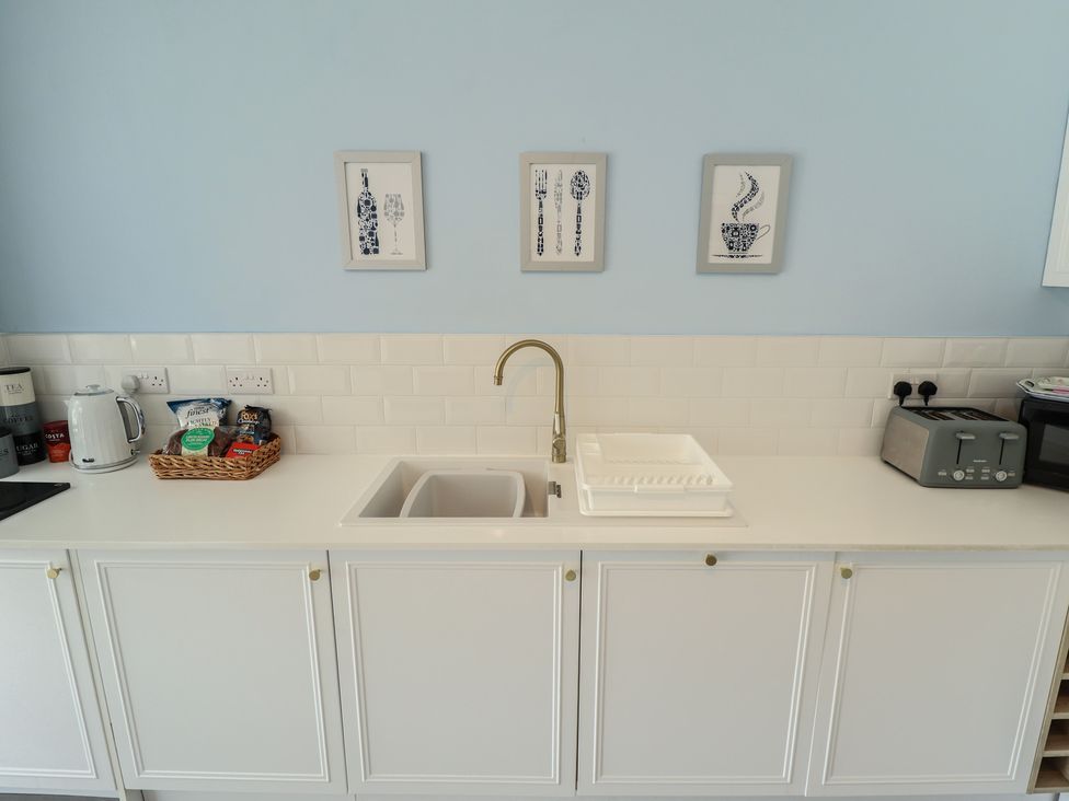 A kitchen with a sink and kettle at The Seaside Retreat in Sutton-On-Sea