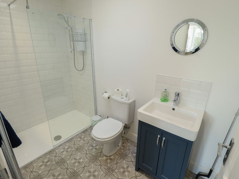 A bathroom with a shower, toilet, and sink at The Seaside Retreat in Sutton-On-Sea