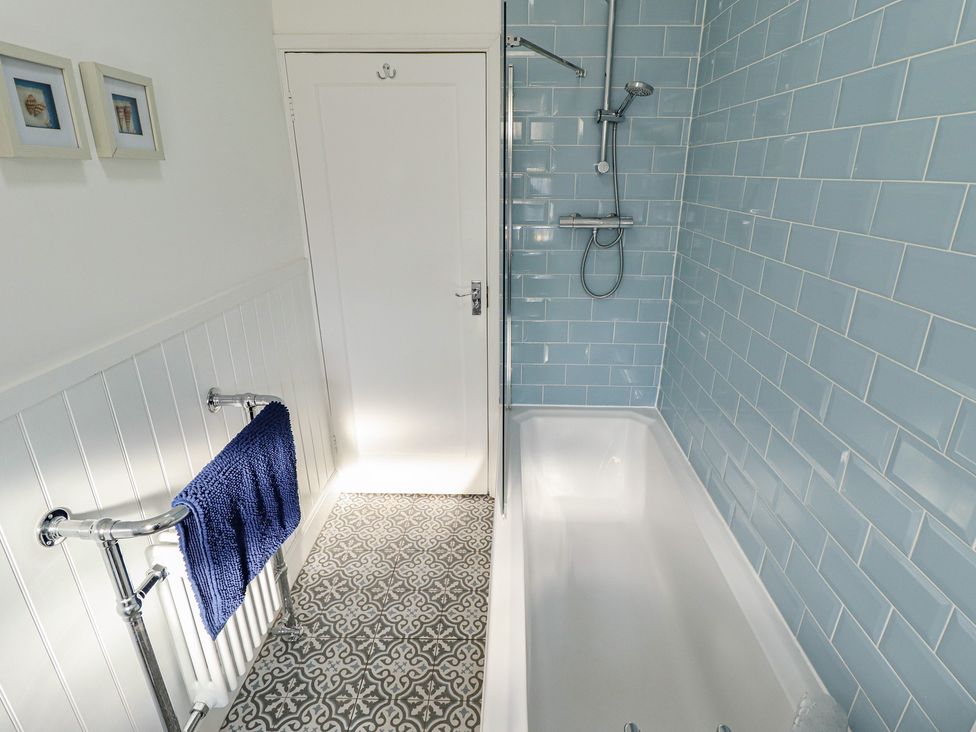 A bathroom with a bathtub and shower at The Seaside Retreat in Sutton-On-Sea