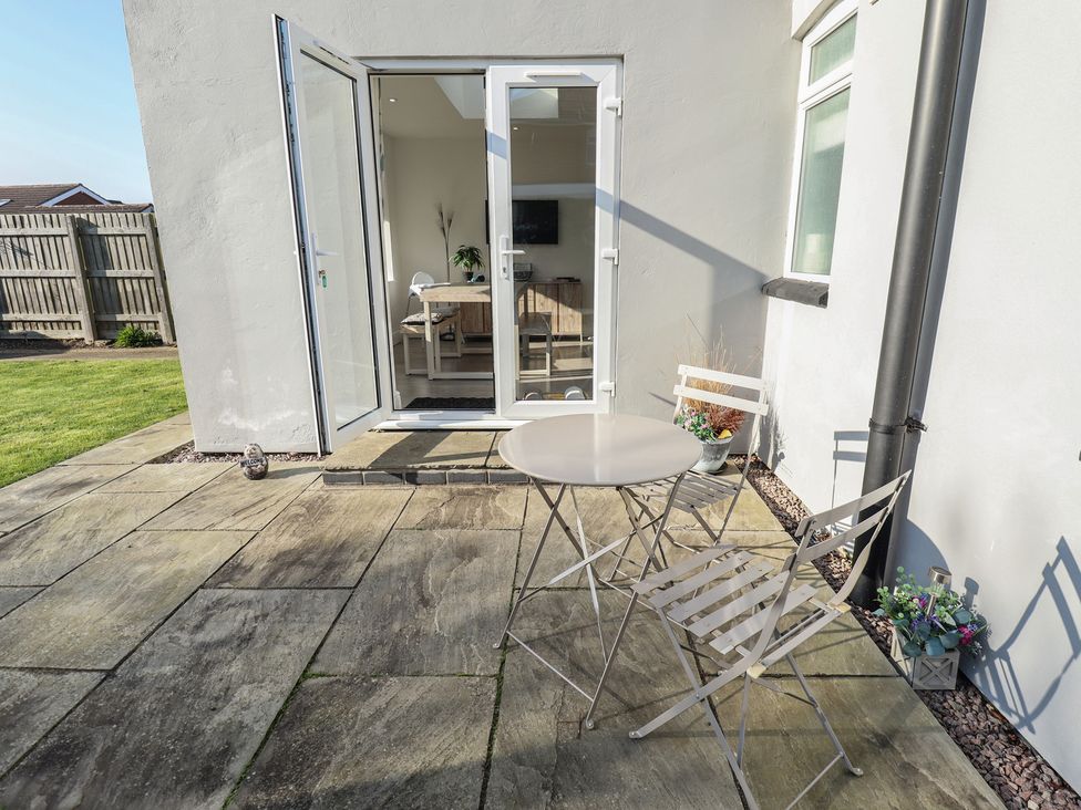 An outdoor patio with a table and chairs at The Seaside Retreat Sutton-On-Sea