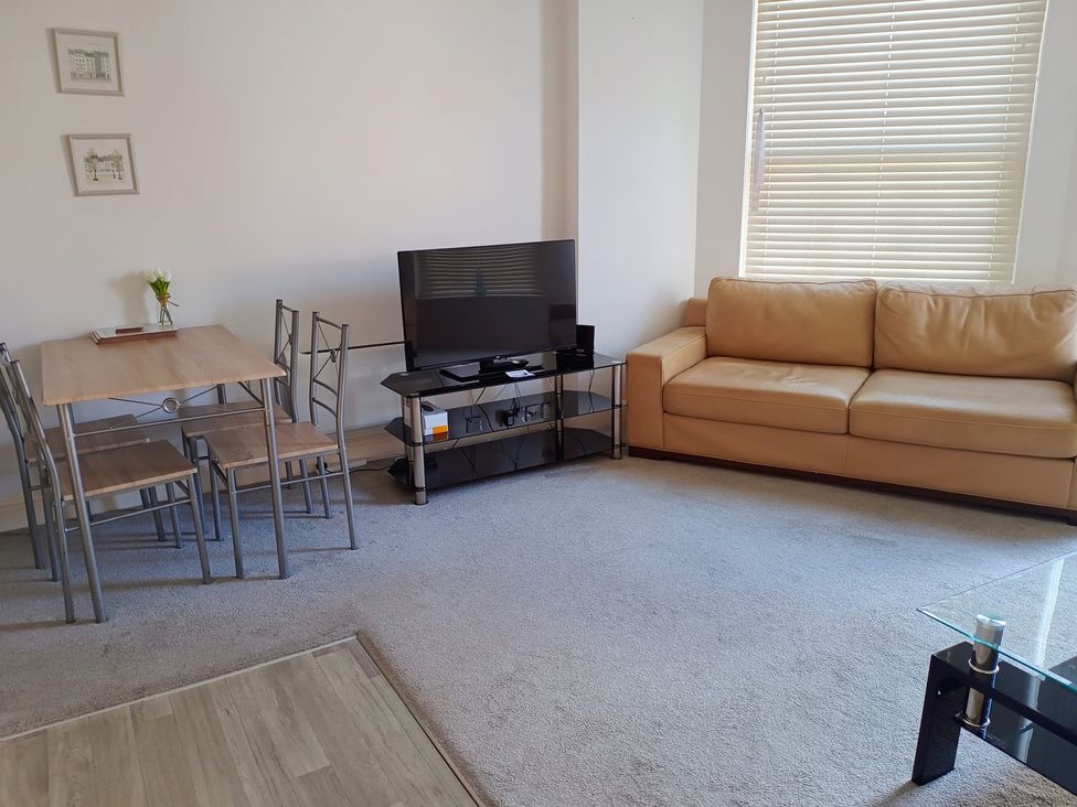 A living room with a sofa and television at Flat 2 in Ipswich