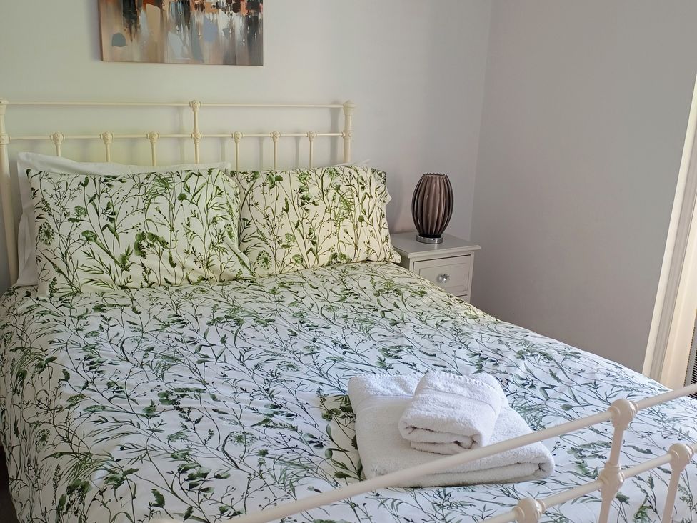 A bedroom with a bed and bedside table at Flat 2 in Ipswich