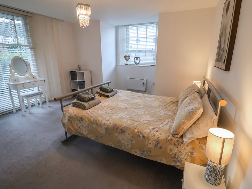A bedroom with a bed and mirror at Stylish Central Ipswich Apartment Near the Waterfront with Parking Ipswich