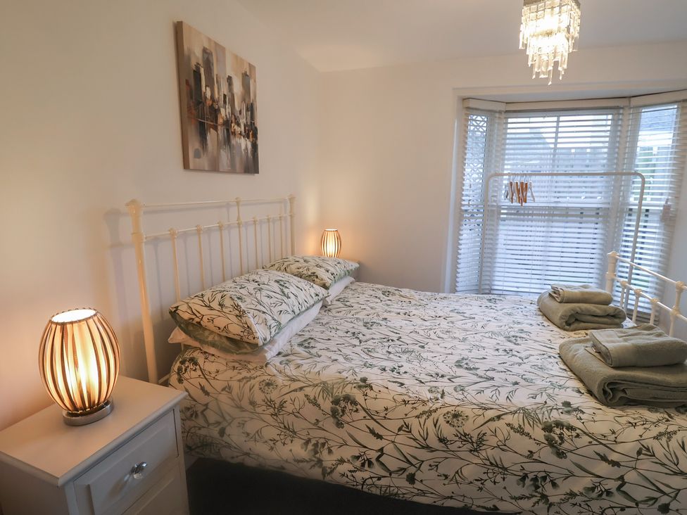 A bedroom with a bed and bedside table at Stylish Central Ipswich Apartment Near the Waterfront with Parking, Ipswich