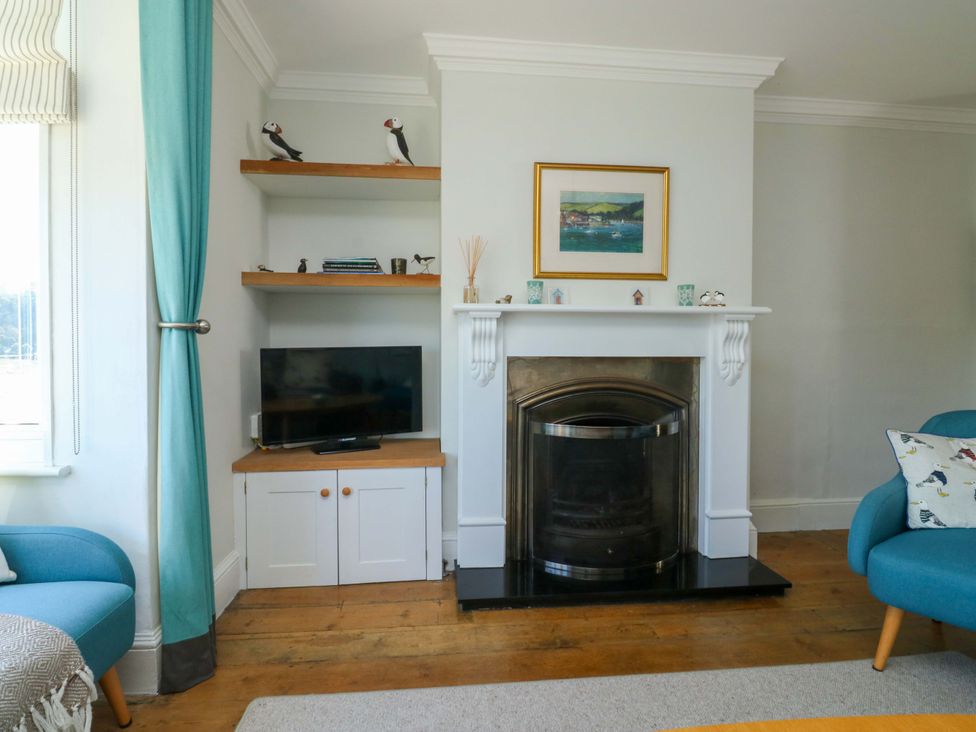 A living room with a fireplace and television at 43 Sandquay Road in Dartmouth
