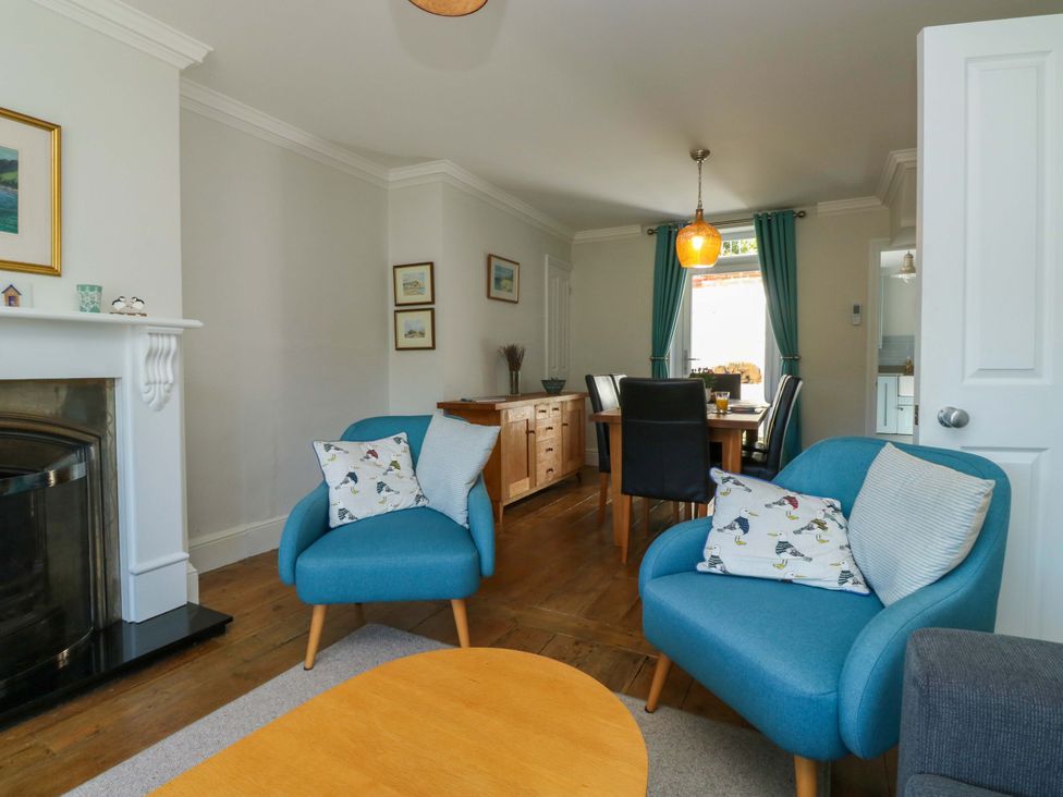 A living room with armchairs and dining area at 43 Sandquay Road, Dartmouth
